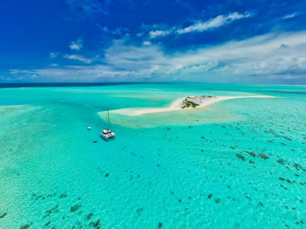 Stunning aerial view of a sailboat near a pristine sandbar in Mauritius' turquoise waters.